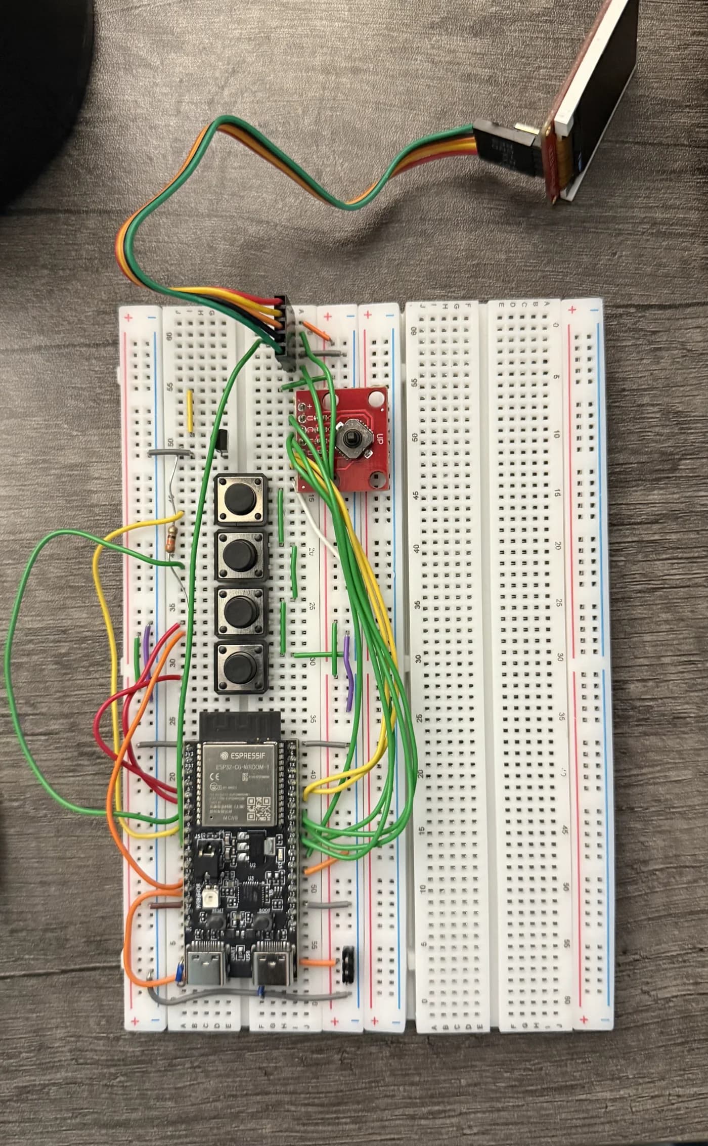 ESP32 prototype assembled on breadboards with buttons, a joystick, and a display